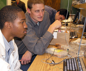 Christopher Schmitz works with ECE 101 student during class lab.